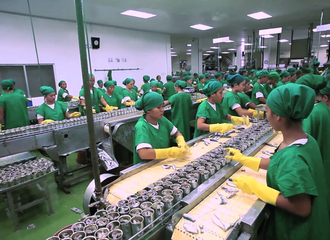 Still from Permex AVP 2015 Workers filling cans on the Permex production line, from the 2015 company film