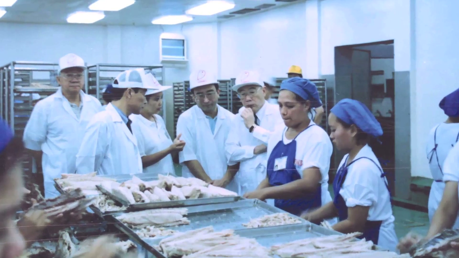 Still from Permex AVP 2015 A team reviewing tuna preparation at the Permex plant, from the 2015 company film